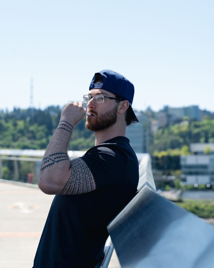 guy vaping thca prodcuts as he watches over the city