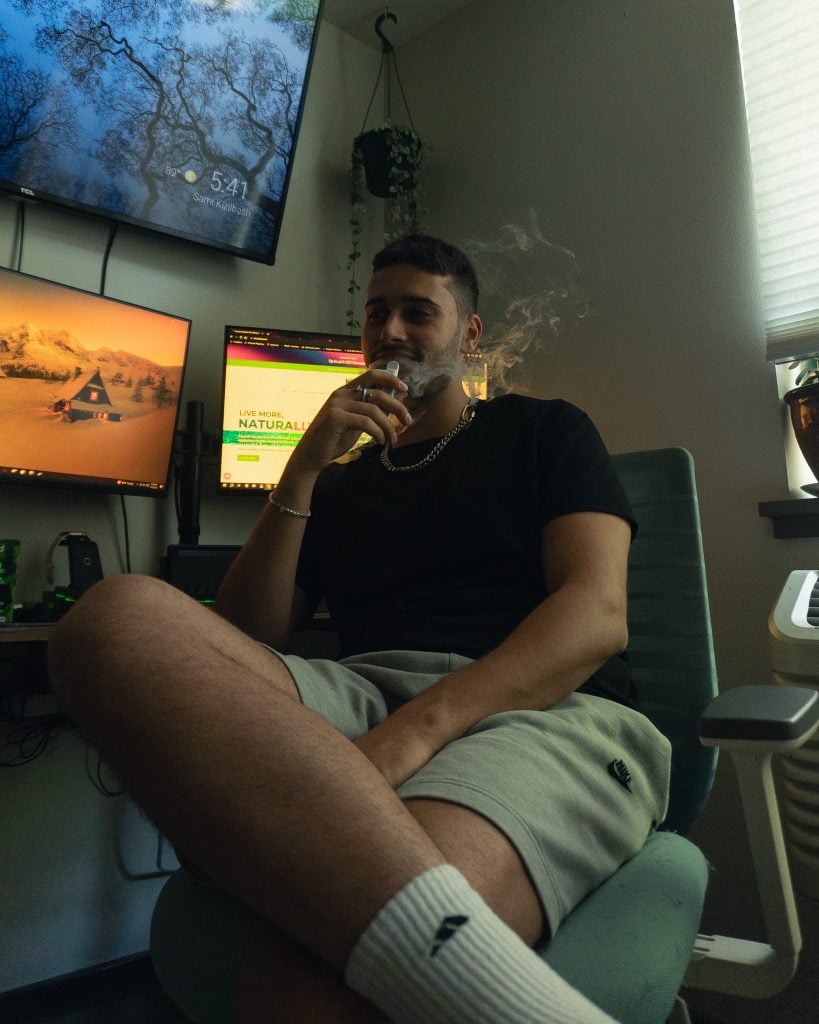 guy sitting on his chair, puffing some thca vape